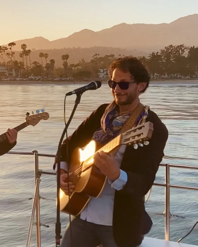 David Segall performing live on a yacht off the Santa Barbara coast at sunset